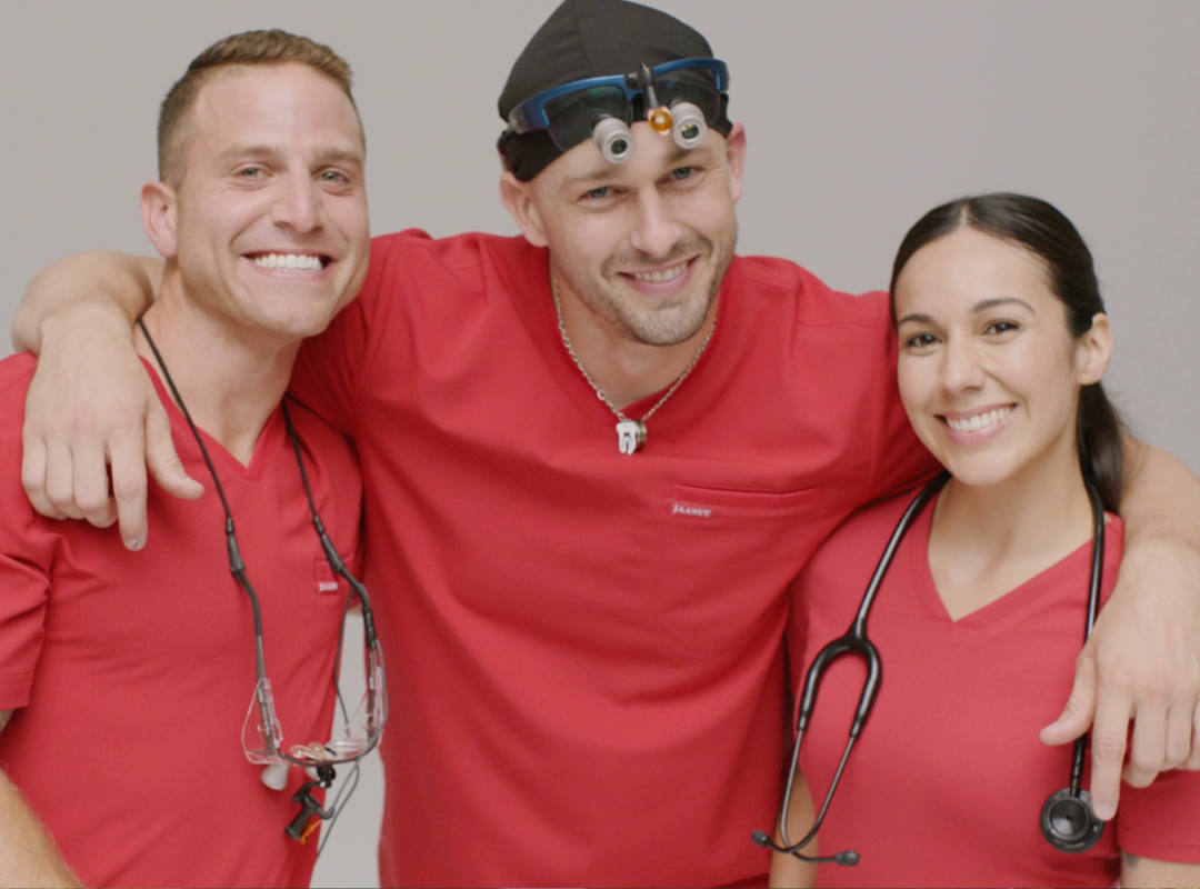 Three nurses in red scrubs