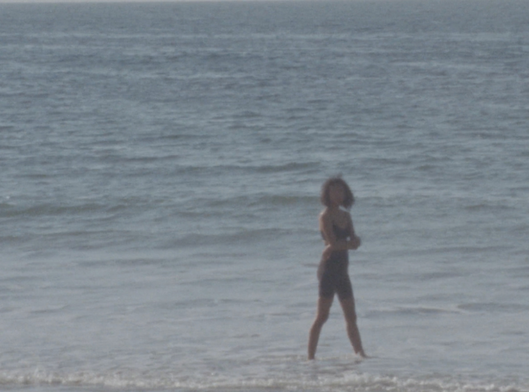 woman standing in the ocean